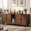 Cat sitting inside walnut hidden litter box furniture cabinet with decorative accents