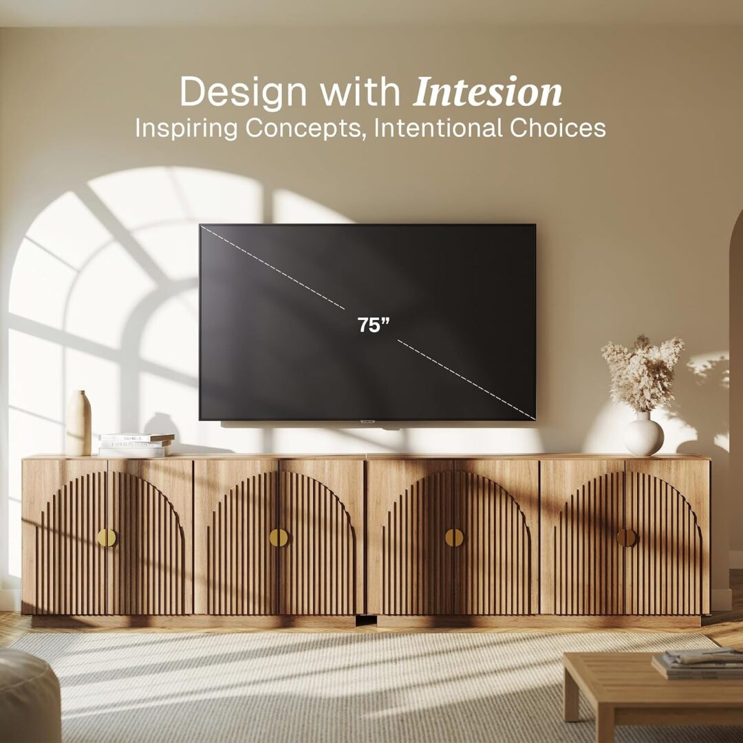 Long fluted TV console with arched doors and gold pulls under a mounted 75-inch television