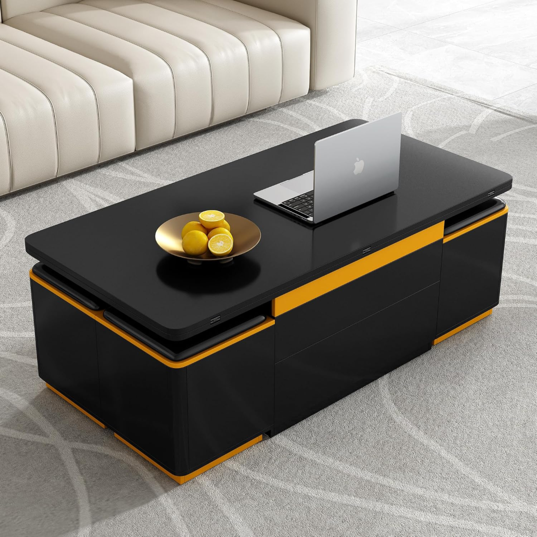 A closed, sleek black rectangular coffee table with a bright orange accent band sitting on a light grey patterned rug, holding a laptop and a gold bowl of lemons.