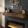 Rustic brown wood fireplace mantel shelf on dark stone wall above electric fireplace with books and vases